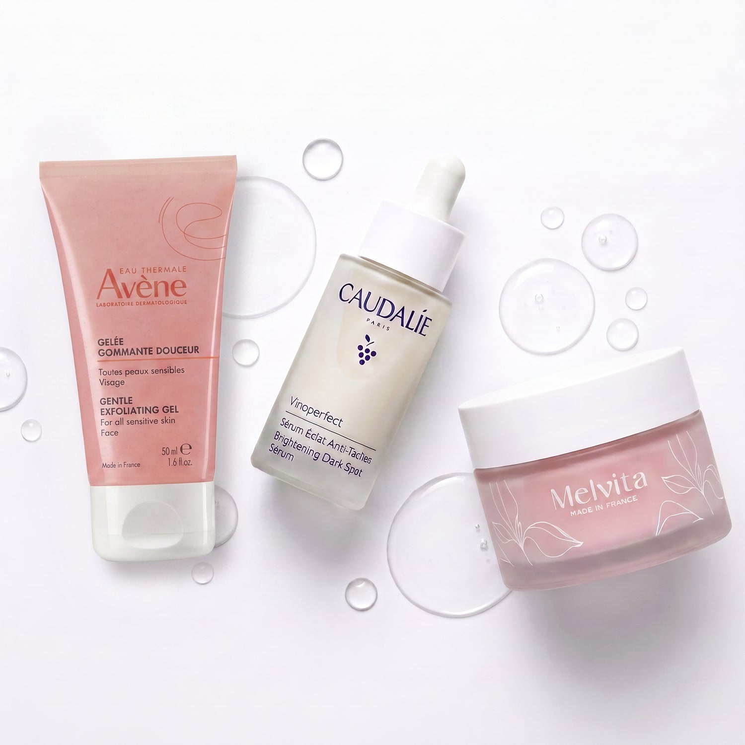 FrenchFormulas The Glow Protocol bundle with skincare products, featuring sleek bottles and natural ingredients in a minimalist setting.