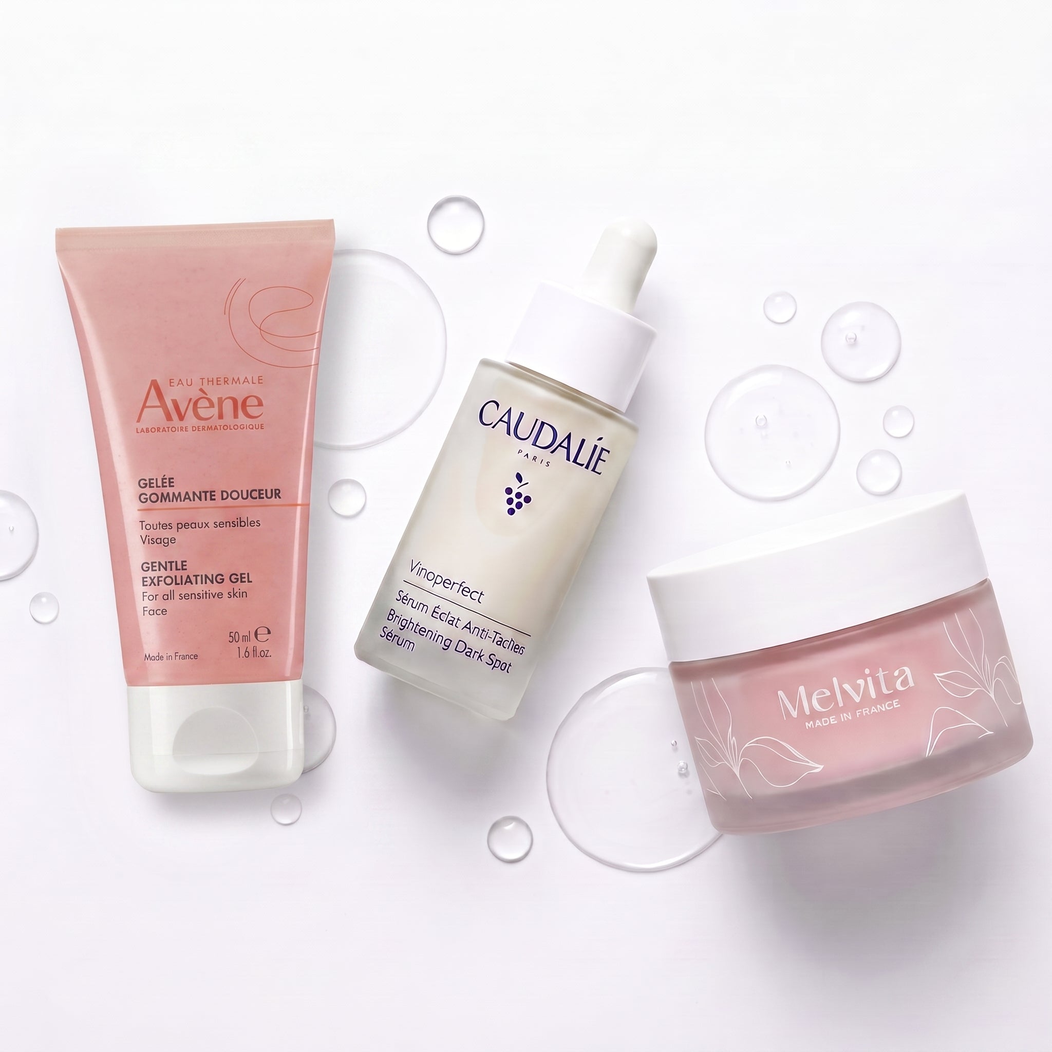 FrenchFormulas The Glow Protocol bundle with skincare products, featuring sleek bottles and natural ingredients in a minimalist setting.